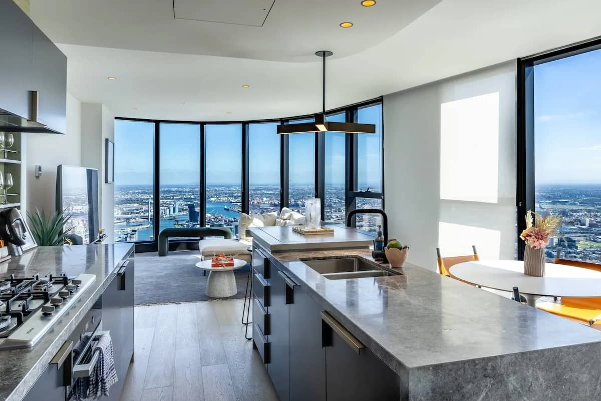 Modern high-rise kitchen with panoramic city skyline views